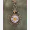 Charming Brass Wall Clock with Decorative Floral Accents and Hanging Detail (1)